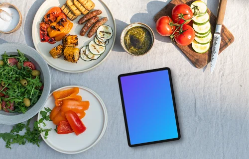 Tablet mockup in the middle of barbecue plates