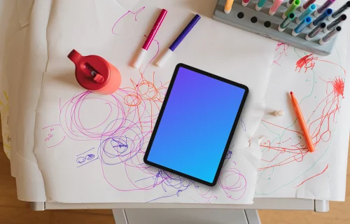 Tablet mockup on a child's drawing table