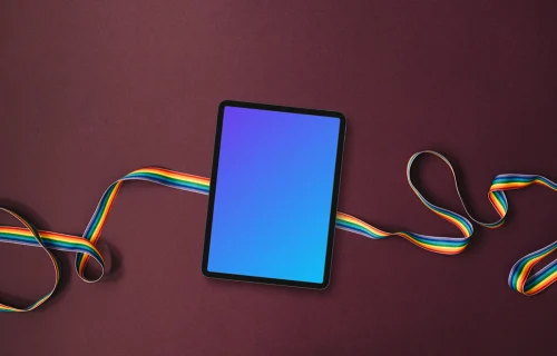 Tablet mockup on a twisted rainbow ribbon