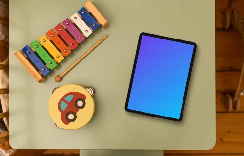 Tablet mockup on kid's study table with educational toys