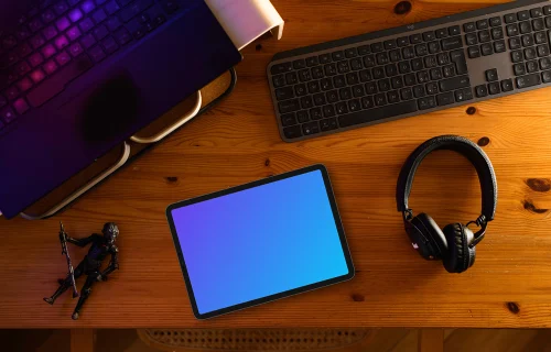 Tablet mockup on wooden desk with creative gadgets