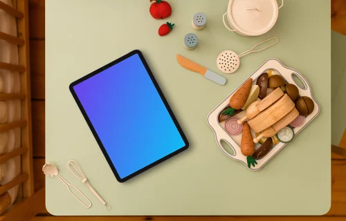 Tablet mockup surrounded by children’s play kitchen set
