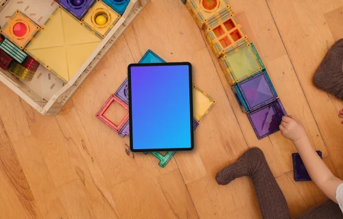 Tablet mockup surrounded by colorful children's blocks