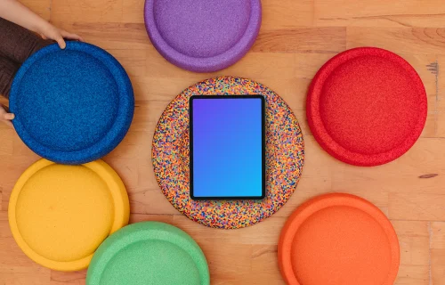 Tablet mockup surrounded by colorful kids seat cushions
