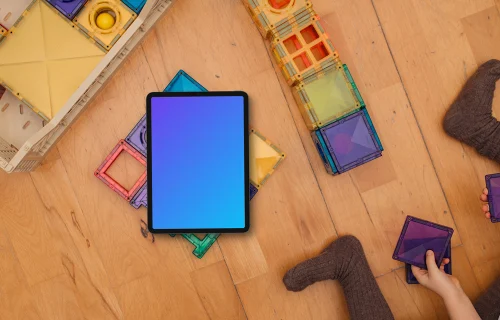 Tablet mockup with colorful building blocks and children's hands