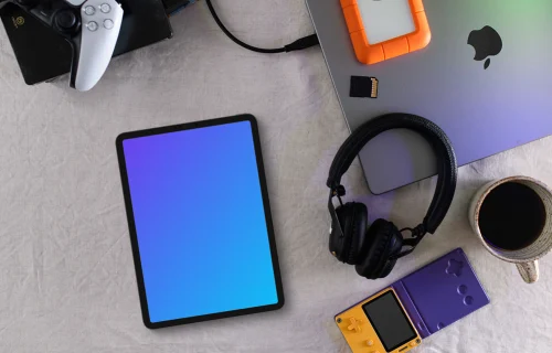 Tablet mockup with gaming devices and laptop on a modern desk