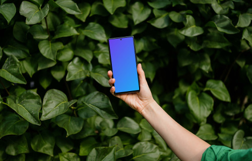 Woman holding a Google Pixel 6 mockup in green theme