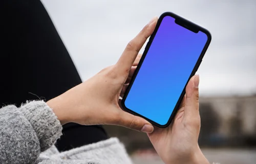 Woman holding a phone mockup in both hands