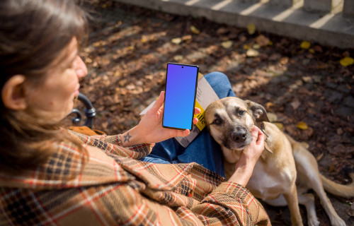 Woman holding a phone while scratching the dog mockup