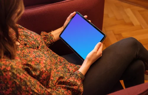 Woman holding a tablet mockup in the lounge