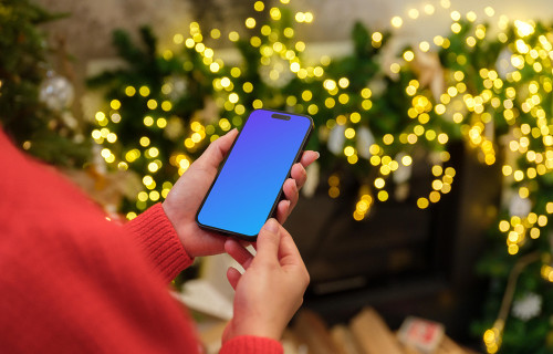 Woman in red sweater holding a smartphone mockup