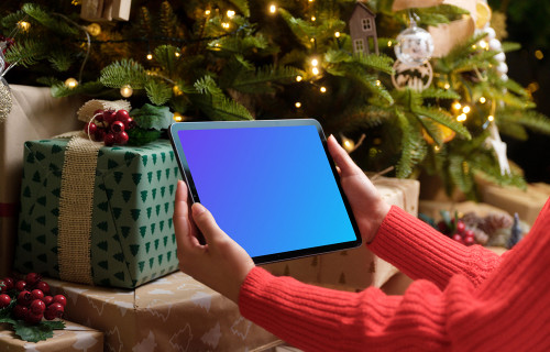 Woman in red sweater holding an iPad mockup