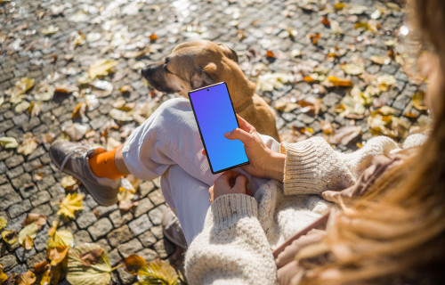 Woman scrolling on a Google Pixel 6 sitting next to dog mockup