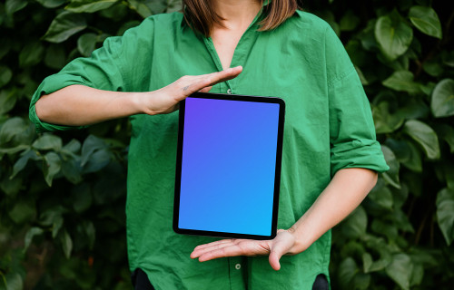 Woman showing off an iPad Air mockup in garden theme