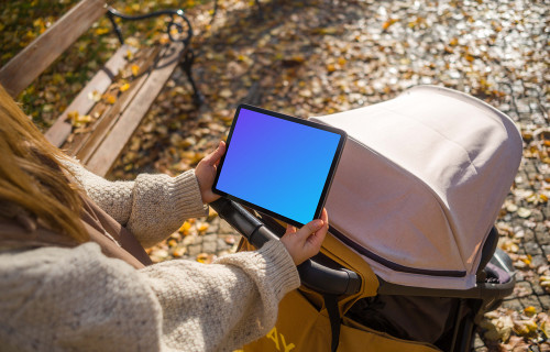 Woman with a baby stroller and tablet mockup