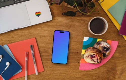 Work desk with a smartphone mockup and pride decorations