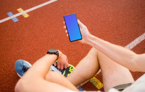 Athlete holding a phone mockup