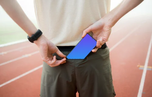 Athlete putting a phone in the pocket mockup