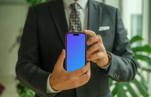 Businessman confidently holding an iPhone mockup