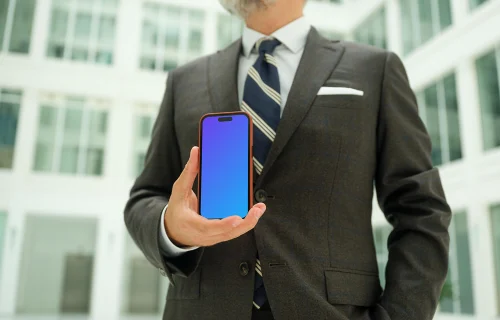Businessman holding an iPhone mockup