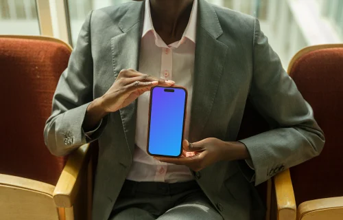 Businesswoman holding an iPhone mockup