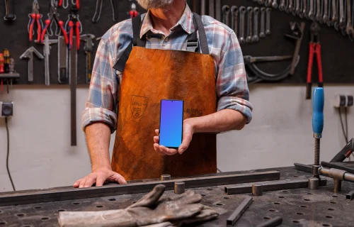 Crafter holding a Google Pixel mockup in the workshop