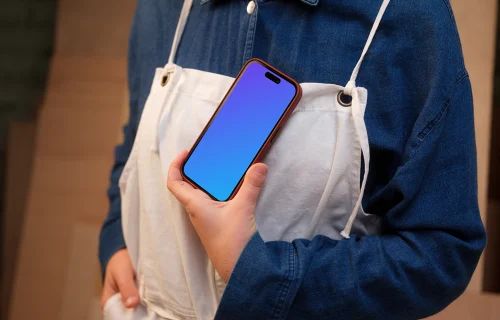 Crafter holding an iPhone mockup in the workshop
