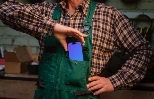 Crafter pulling out iPhone 14 Pro of his pocket