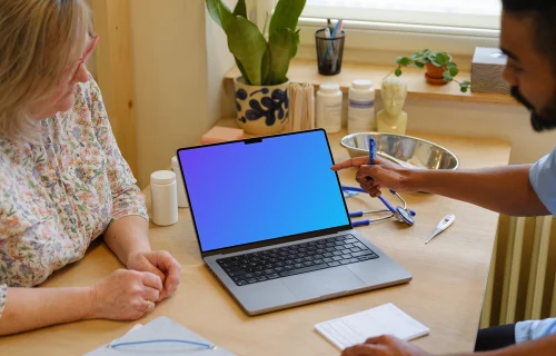 Doctor pointing to MacBook Pro 14" mockup