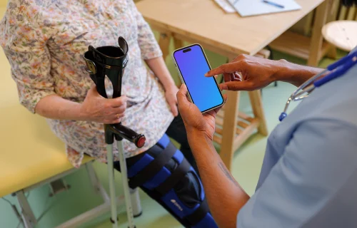 Doctor typing on an iPhone