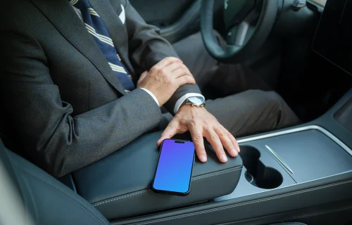 Entrepreneur sitting in Tesla with iPhone mockup