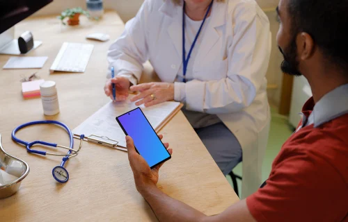 Examination at the doctor and patient holding a phone