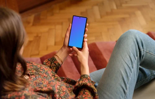 Female displaying Google Pixel mockup in wooden ambience of the lounge