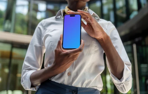 Female entrepreneur holding an iPhone 14 Pro mockup