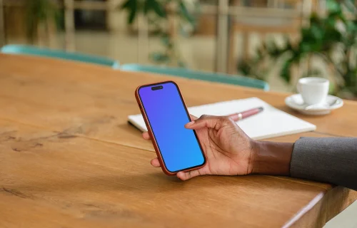 Female entrepreneur in office with iPhone in her hand