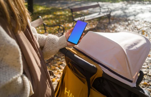Female hand holding a Google Pixel 6 during autumn mockup