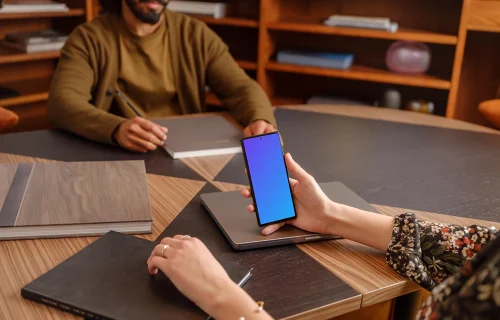 Female hand holding a Google Pixel 6 mockup in the office