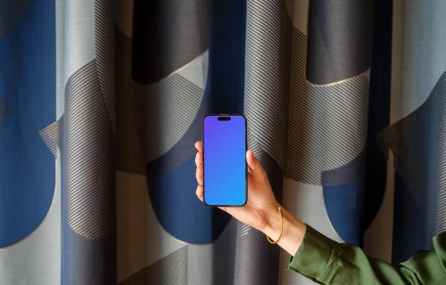 Female hand holding a phone in office