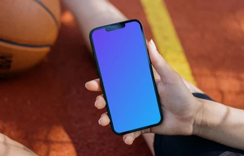 Female hand holding an iPhone 13 mockup