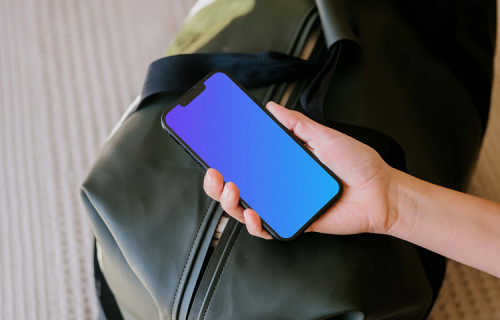 Female hand holding an iPhone mockup