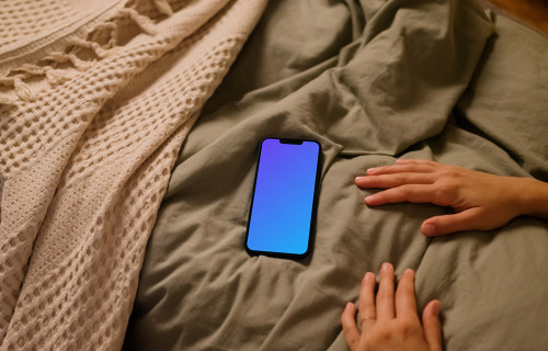 Female hands next to an iPhone 13 mockup