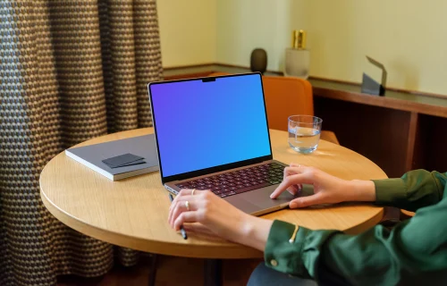 Female in the office working on a MacBook mockup