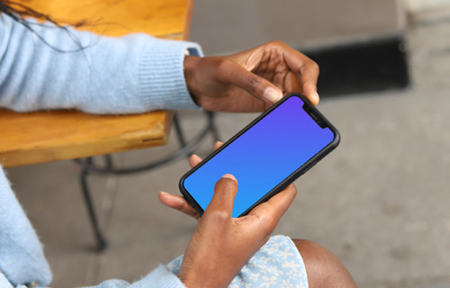 Female pointing on iPhone 12 mockup