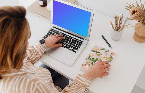 Female working on a MacBook Air mockup