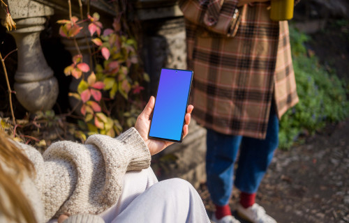 Hand holding a Google Pixel 6 in the park mockup
