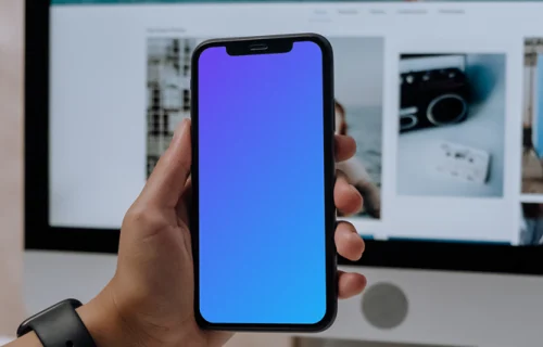 Hand holding an iPhone 12 mockup