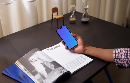 Hand holding an iPhone 14 Pro mockup