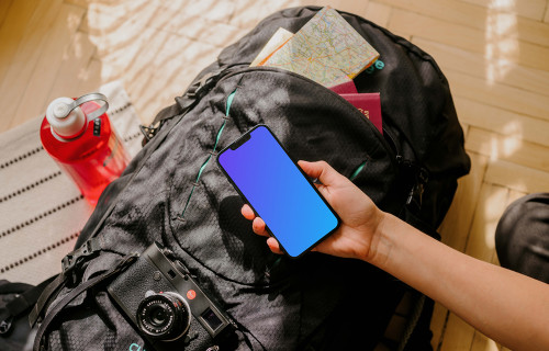 Hand holding an iPhone mockup