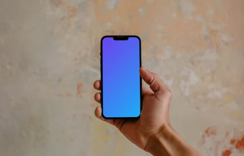Hand holding iPhone 13 mockup