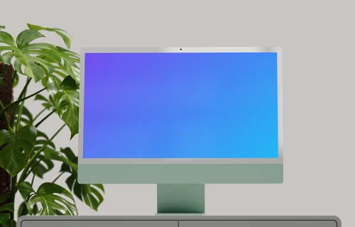iMac mockup on a minimalist desk with plants